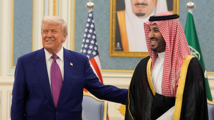 President Donald Trump and Saudi Crown Prince Mohammed bin Salman gesture as they meet delegations at the Royal Palace in Riyadh, Saudi Arabia, May 13, 2025.