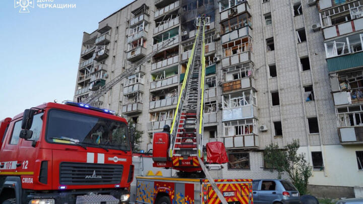 Firefighters extinguish a fire in a residential building following a Russian attack in the city of Smila, Cherkasy region in a handout photograph taken and released by the State Emergency Service of U