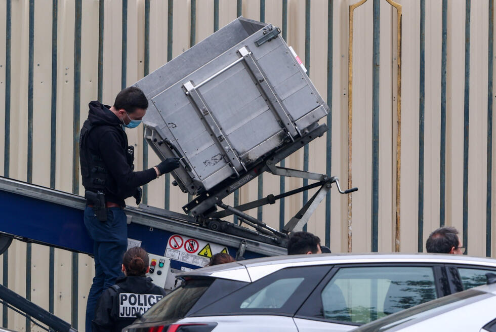 Police officers work at a crane believed to have been used in a robbery at the Louvre museum in Paris, France, October 19, 2025.