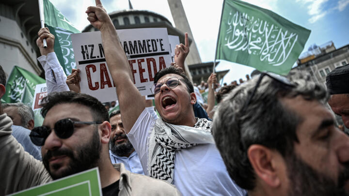 Protesters demonstrate against cartoonists of satirical magazine LeMan outside Taksim mosque in Istanbul on July 1, 2025.