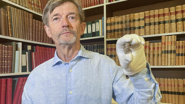 Denmark's national museum curator Peter Pentz shows a gaming piece which is believed to be the first portrait of a Viking, on August 26, 2025 in Copenhagen.