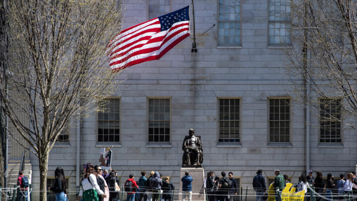Demonstrators with signs in Harvard Yard after a rally was held against President Donald Trumps attacks on Harvard University at Harvard University, Massachusetts on April 17, 2025.