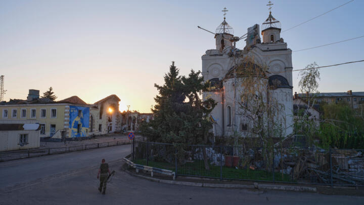 A soldier passes by a damaged church in Kostyantynivka, the site of heavy battles with Russian troops, in the Donetsk region, Ukraine, Saturday, April 19, 2025.