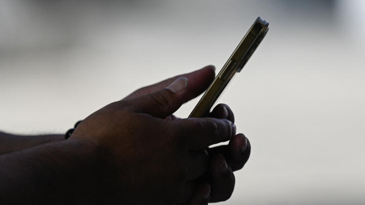 A person uses an Apple iPhone in Beijing on September 12, 2023.