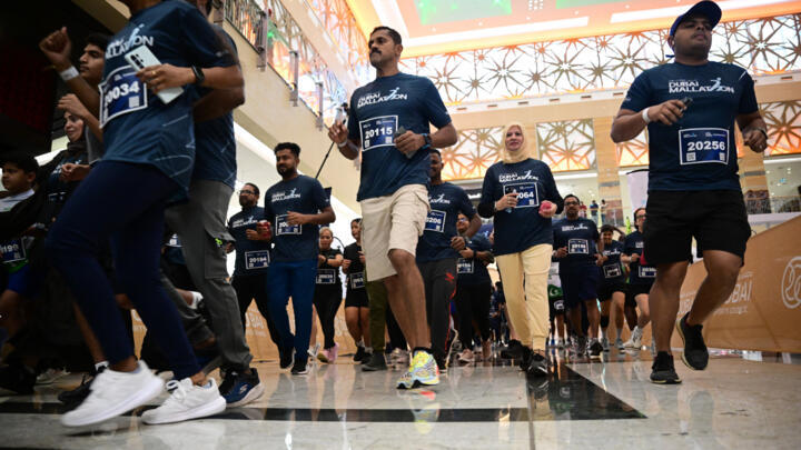 People take part in Dubai Mallathon 2025, at the City Centre Mirdif mall in Dubai on August 9, 2025. Dubai Mallathon is a citywide community wellness initiative aimed at encouraging people to remain active during the hot summer, by transforming the city's major shopping malls into morning fitness spaces.