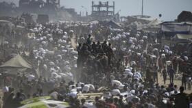 Palestinians carry sacks of flour taken from a humanitarian aid convoy in the outskirts of Beit Lahiya, northern Gaza Strip, August 1, 2025.