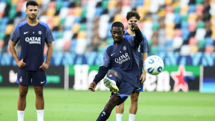 Paris Saint-Germain's Ousmane Dembélé shoots the ball during a training session at the Friuli stadium in Udine, Italy, on August 12, 2025. 