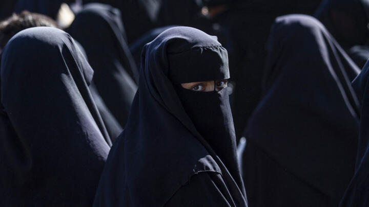 Women held in a Kurdish-run detention camp for suspected relatives of Islamic State (IS) group jihadists, in northeast Syria, on August 28, 2025.