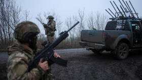 A serviceman of the 93rd Kholodnyi Yar Separate Mechanized Brigade of the Ukrainian Armed Forces checks the sky as he looks out for Russian combat drones.