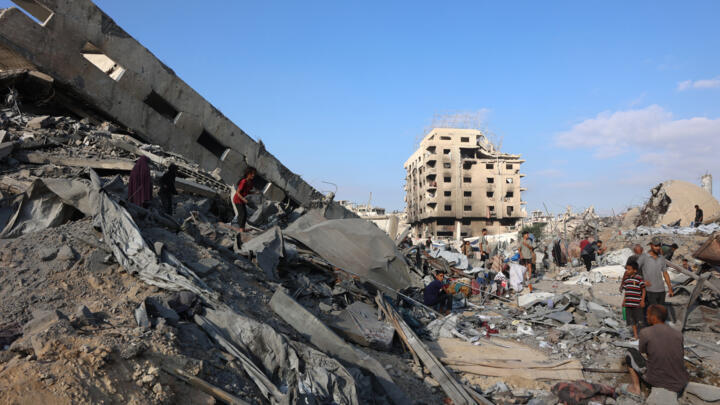 Palestinians inspect the damage after an overnight strike on the Sheikh Radwan Health Centre run by the United Nations Relief and Works Agency for Palestine Refugees (UNRWA) in the north of Gaza City.