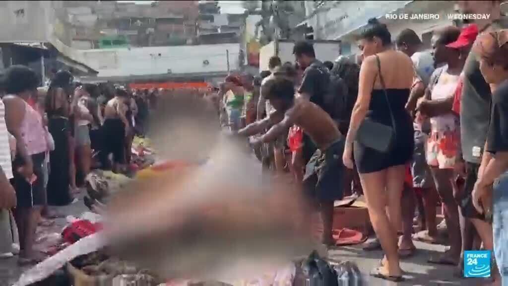 Brazilians in a Rio favela line up bodies after the city's deadliest police raid