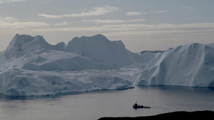 A fishing vessel sails in the ice fjord near Ilulissat, Greenland, September 12, 2017.