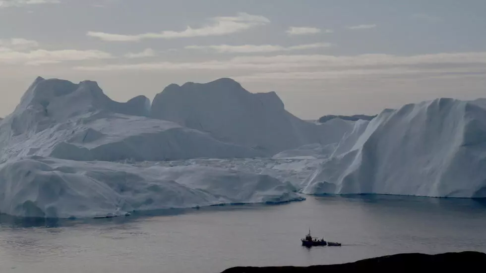 A fishing vessel sails in the ice fjord near Ilulissat, Greenland, September 12, 2017.