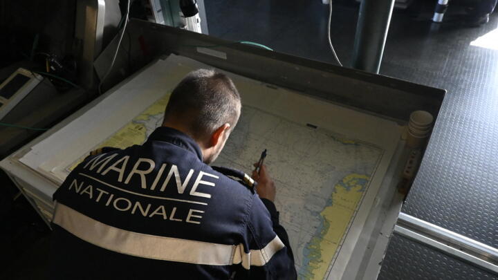 Navigator Second Master Timonier, Quentin, takes measures on a map of the North Sea on board of French Navy frigate Bretagne ahead of NATO Neptune Strike 2025 exercise on September 22, 2025.