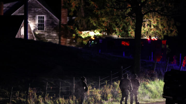Law enforcement personnel surround a house in Bowdoin as they search for the suspect in the mass shootings in Lewiston, Maine, USA on October 26, 2023. 
