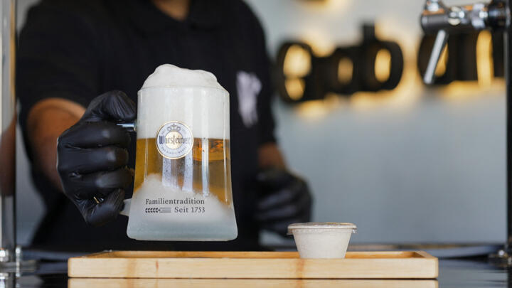 An employee pours a draft non-alcoholic beer at a cafe in Riyadh, Saudi Arabia