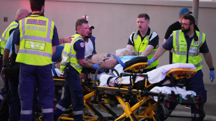Emergency workers transport a person on a stretcher after a reported shooting at Bondi Beach in Sydney, Sunday, Dec. 14, 2025.