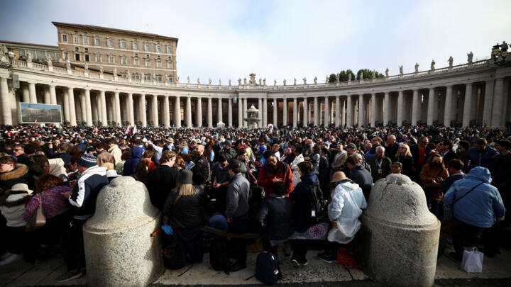 People gather before the funeral mass for Pope Francis in St Peter's Square, Vatican City, on April 26, 2025. 