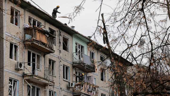 Emergency responders work at the site of a Russian drone strike on an apartment building, amid Russia's attack on Ukraine, in Kyiv, Ukraine December 23, 2025