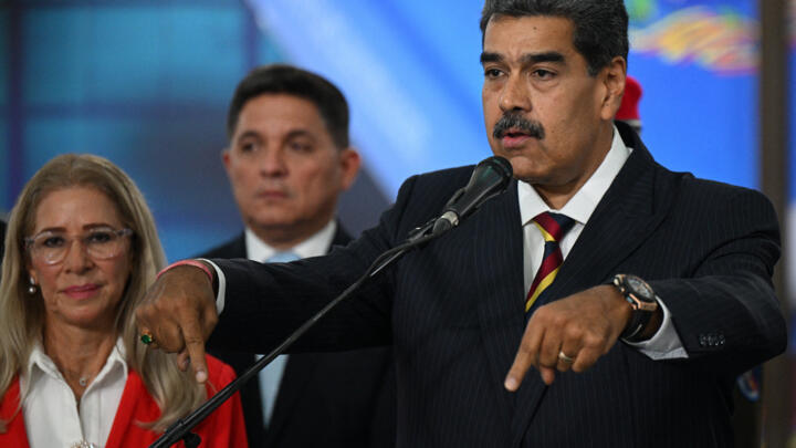 Venezuela's President Nicolas Maduro addresses the media next to his wife Cilia Flores after appearing before the Supreme Court of Justice (TSJ) in Caracas on August 9, 2024.