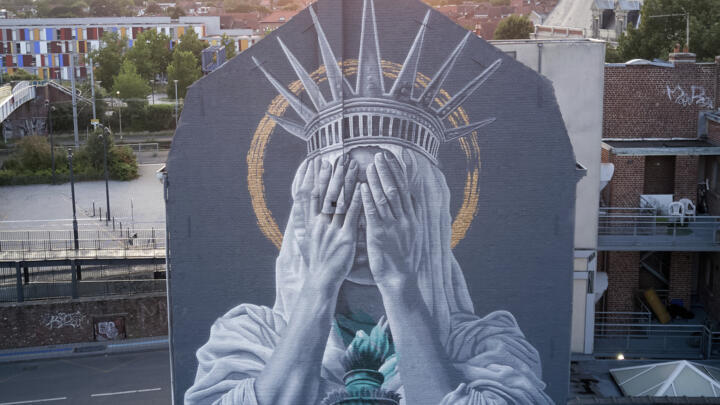 A mural by Dutch artist Judith de Leeuw shows the Statue of the Liberty covering her eyes with her hands in Roubaix, northern France.