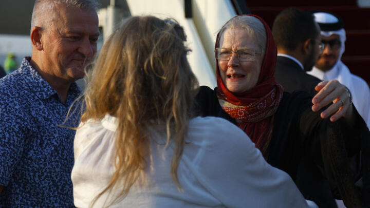 Barbie Reynolds hugs her daughter Sarah Entwistle after landing at the airport in Doha on September 19, 2025. Peter and Barbie Reynolds have been freed in Afghanistan after several months in detention