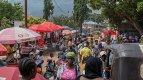 People walk through Maendeleo market in Uvira, South Kivu province, Democratic Republic of the Congo, on December 15, 2025.