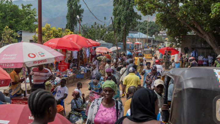 People walk through Maendeleo market in Uvira, South Kivu province, Democratic Republic of the Congo, on December 15, 2025.