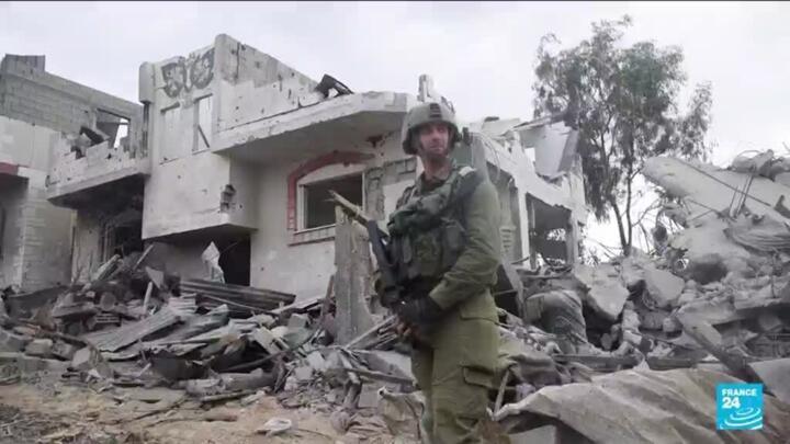 Israeli soldier stands in front of rubble in northern Gaza on November 14, 2023.