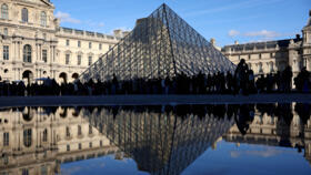 People stand outside the Louvre Museum, after French police arrested suspects in the Louvre heist case, in Paris, France October 26, 2025