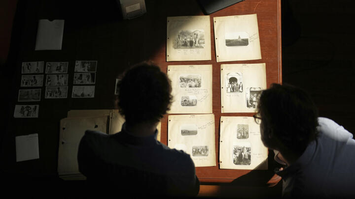 University of Pennsylvania doctoral student Marc Marin Webb, left, and University of Victoria postdoctoral fellow Nathaniel Brunt, view images of photos of the Yazidi people.
