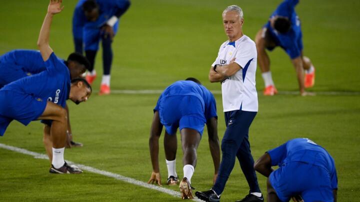 France manager Didier Deschamps looks on as his players stretch during a training session at the Jassim-bin-Hamad Stadium in Doha on November 20, 2022, ahead of the Qatar 2022 World Cup football tournament.