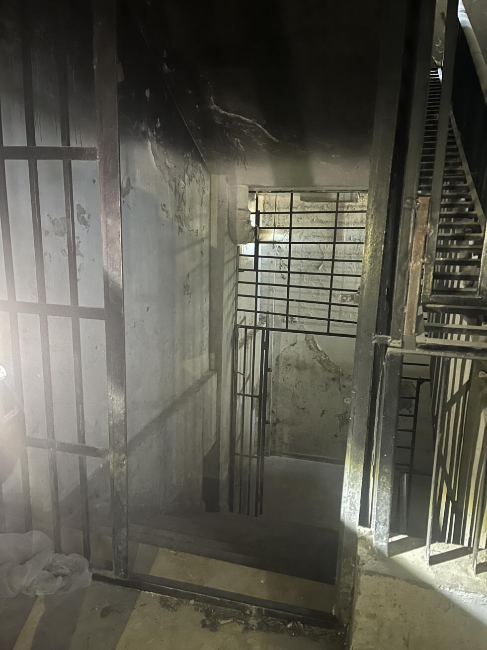 A barred door leads to the basement of the Palestine Branch, where the cells are located, Damascus, May 29, 2025.