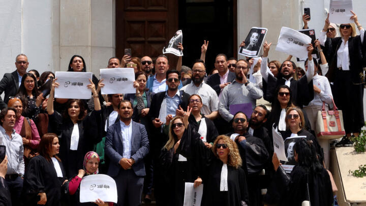 Lawyers carry banners during a protest against the arrest of Sonia Dahmani, a prominent lawyer critical of the president, outside the Palace of Justice building in Tunis, Tunisia May 13, 2024.