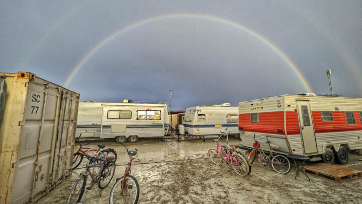 A double rainbow appears over flooding on a desert plain on September 1, 2023, after heavy rains turned the annual Burning Man festival site in Nevada’s Black Rock desert into a mud pit.