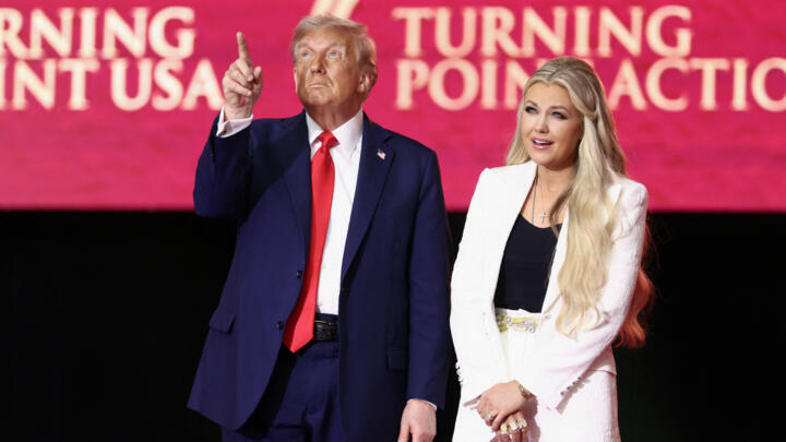 US President Donald Trump reacts next to Erika Kirk, widow of Charlie Kirk, after speaking at the public memorial service for right-wing activist Charlie Kirk at State Farm Stadium in Arizona.