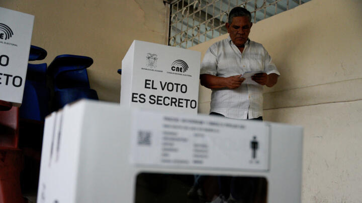 A man stands at a polling station during a referendum to decide whether to allow the return of foreign military bases to Ecuador on November 16, 2025.
