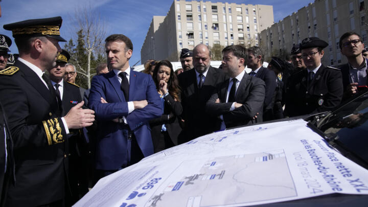 French President Emanuel Macron, second left, listens to officials during a visit focusing on security and the fight against drug trafficking on March 19, 2024 in Marseille, southern France.