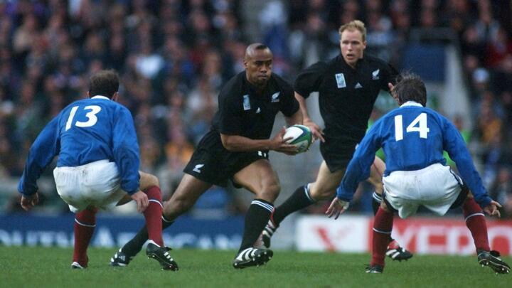 File photo: New Zealand winger Jonah Lomu charges in front of French centre Richard Dourthe and winger Philippe Bernat-Salles during the Rugby World Cup semi-final match between New Zealand and France at Twickenham stadium on October 31, 1999.