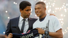 PSG President Nasser Al-Khelaifi (left) speaks to Kylian Mbappé after the striker signed a three year extension to his contract in May 2022.