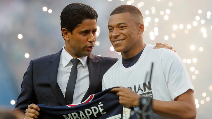 PSG President Nasser Al-Khelaifi (left) speaks to Kylian Mbappé after the striker signed a three year extension to his contract in May 2022.