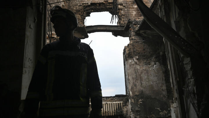 A rescue worker looks up at the damaged government building in Kyiv, on September 8, 2025.