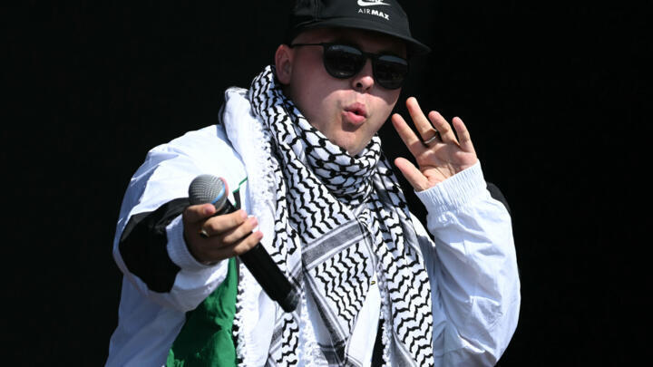 Mo Chara, member of Irish rap group Kneecap, performs on the West Holts stage on the fourth day of the Glastonbury Festival at Worthy Farm in the village of Pilton, Somerset, southwest England, June 2