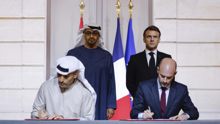 French Pres Macron and UAE counterpart bin Zayed Al Nahyan, look on as French Minister for Europe Barrot and CEO of Mubadala Investment Company Al Mubarak sign an agreement on AI in Paris, Feb. 6 2025