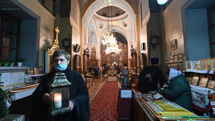A Ukrainian Orthodox priest carries a candle with Holy Fire brought from Jerusalem in a church next to Kiev-Pechersk Lavra monastery in Kiev on April 18, 2020, on the eve of Orthodox Easter. 