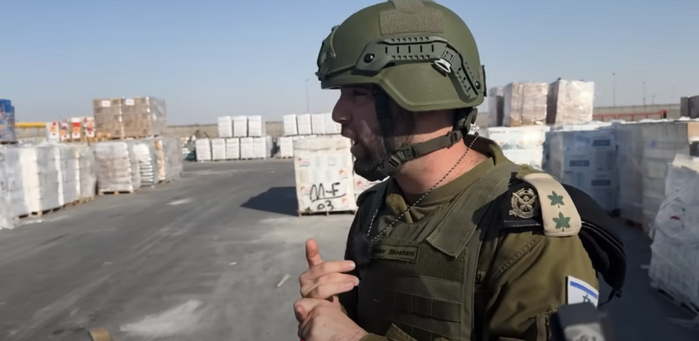 An Israeli army spokesperson is interviewed by several influencers and videographers, including Cam Highby, in Kerem Shalom on August 26, 2025.
