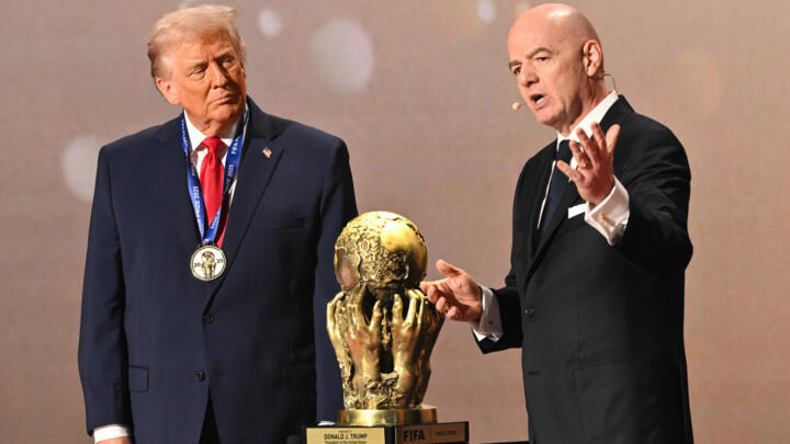 President Donald Trump as FIFA President Gianni Infantino presents him with the FIFA Peace Prize during the draw for the 2026 soccer World Cup at the Kennedy Center in Washington on December 5, 2025.
