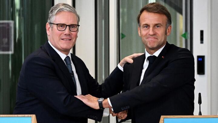 In this file photo, Britain's Prime Minister Keir Starmer (L) and France's President Emmanuel Macron (R) embrace during a joint press conference in north-west London, on July 10, 2025.