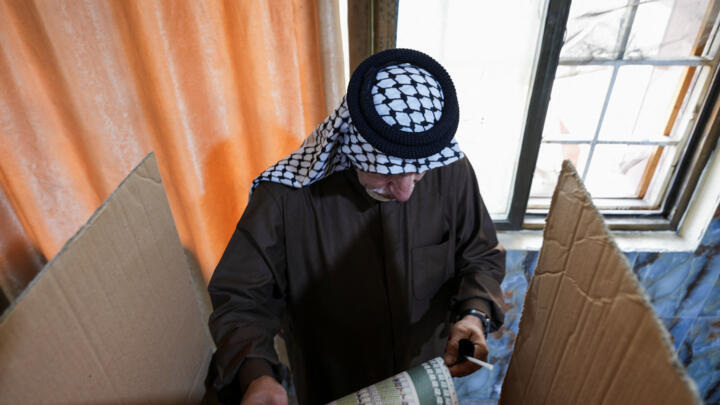 A man votes at a polling station during the parliamentary election in Basra, Iraq, November 11, 2025.