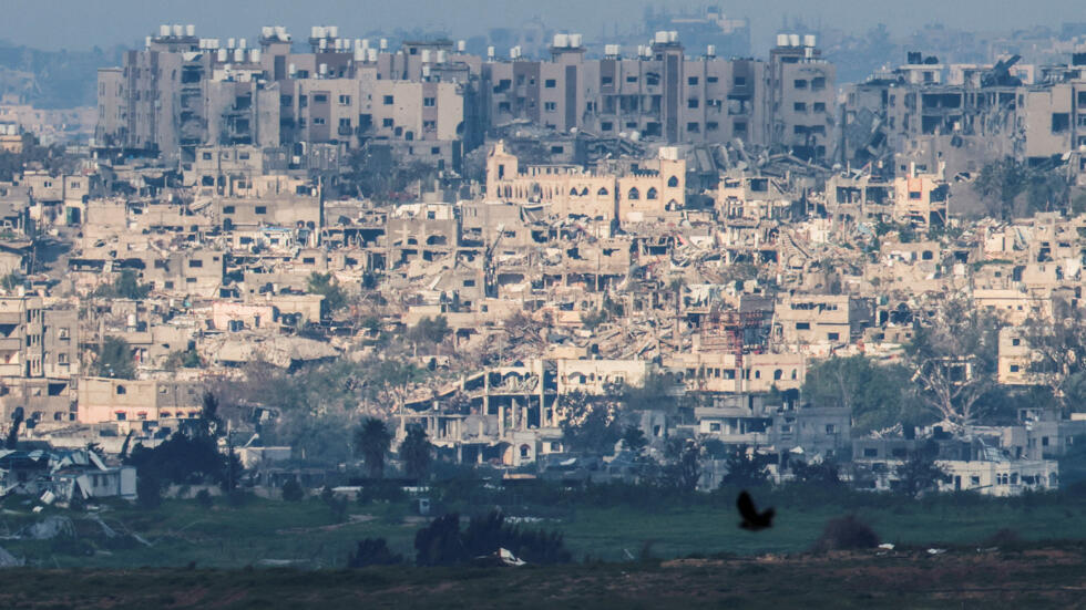 A bird flies past as damaged buildings stand amid the rubble in central Gaza, amid the ongoing conflict between Israel and the Palestinian militant group Hamas, near the Israel-Gaza border.